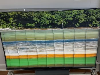 Before repair: Samsung 65 inch QLED TV with cracked LCD panel and vertical lines